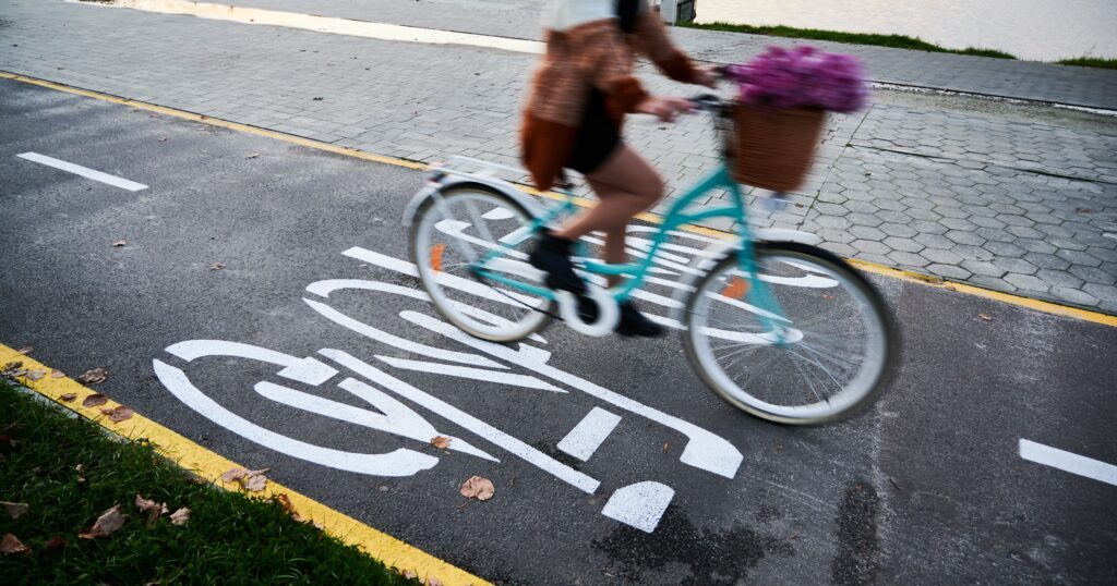 woman-riding-bicycle-on-bike-lane-in-centre-city-1-min